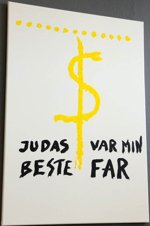 «Judas var min beste far». Et dollartegn der streken går ned som et kors.